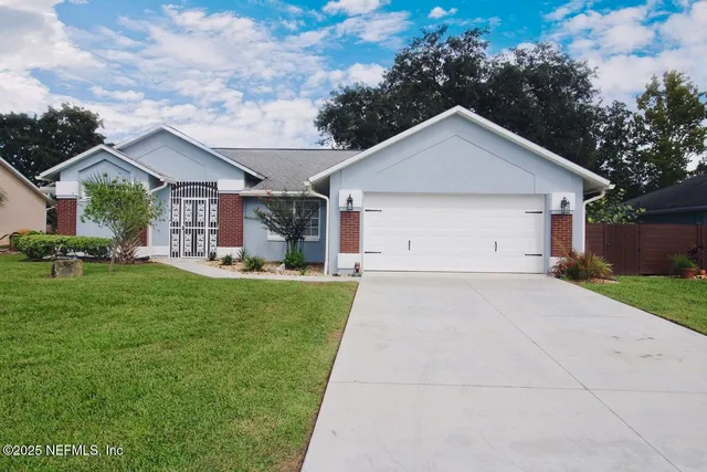 a front view of house with yard and green space