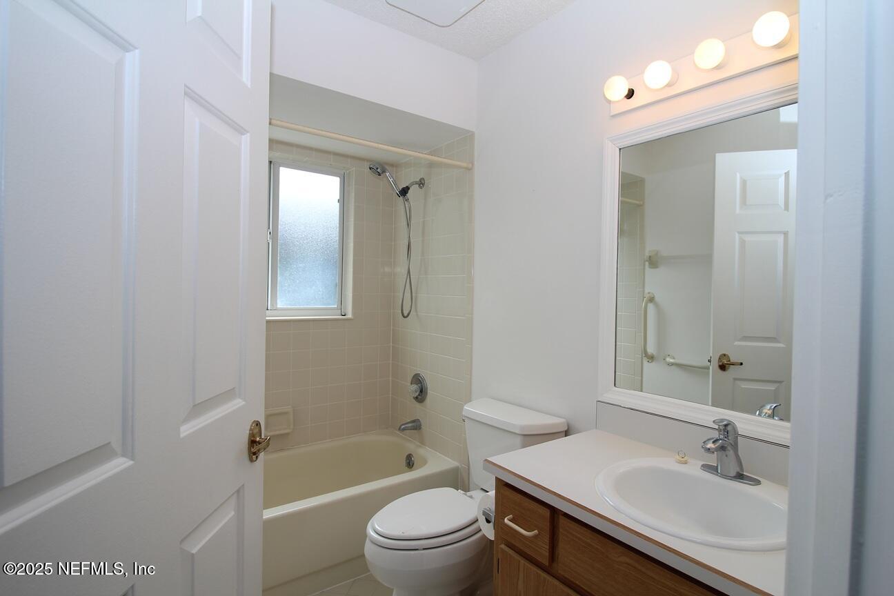 48 Westover Lane Palm Coast, FL 32164 - Photo 17 of 20 a bathroom with a sink a toilet and shower