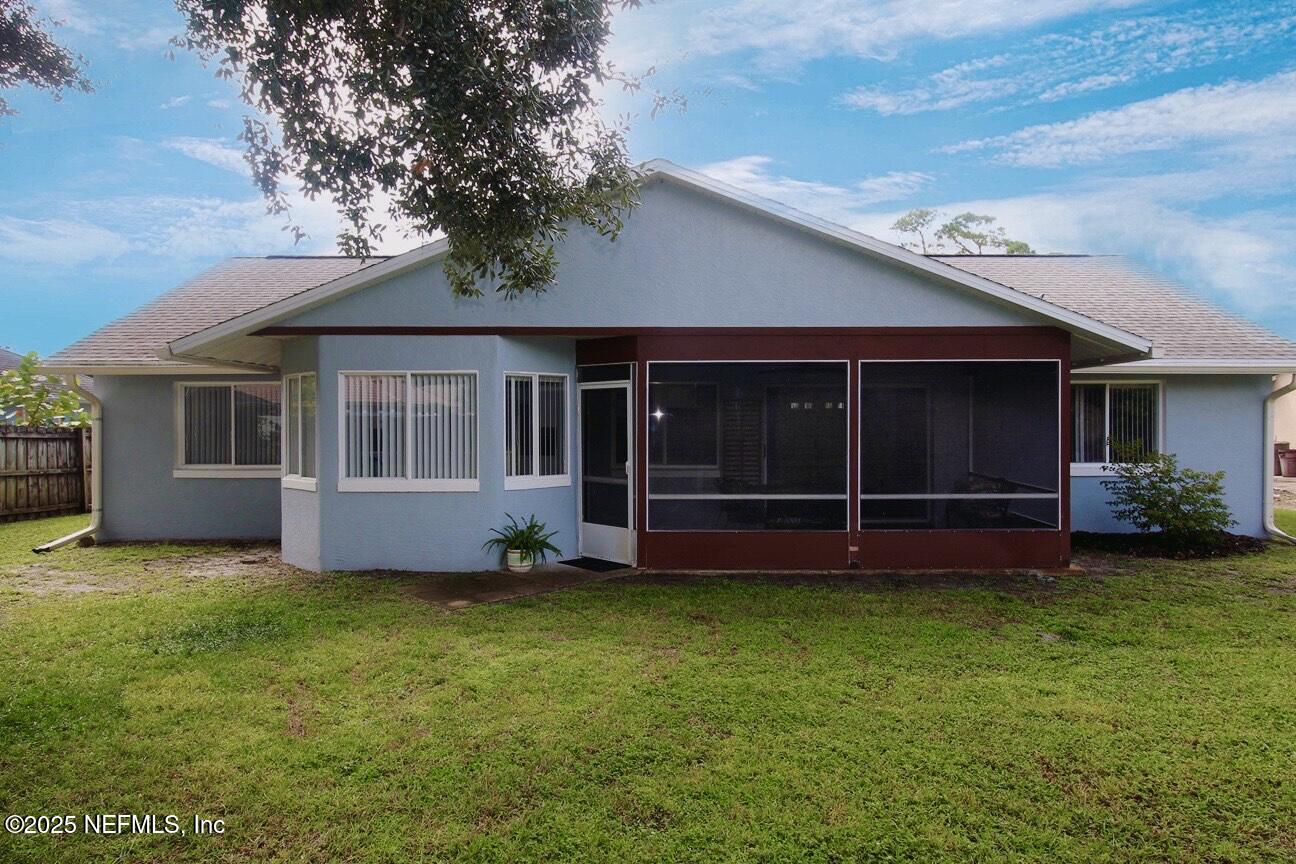 48 Westover Lane Palm Coast, FL 32164 - Photo 20 of 20 a view of a house with a yard and a large tree