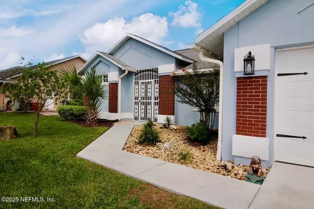 a front view of a house with garden