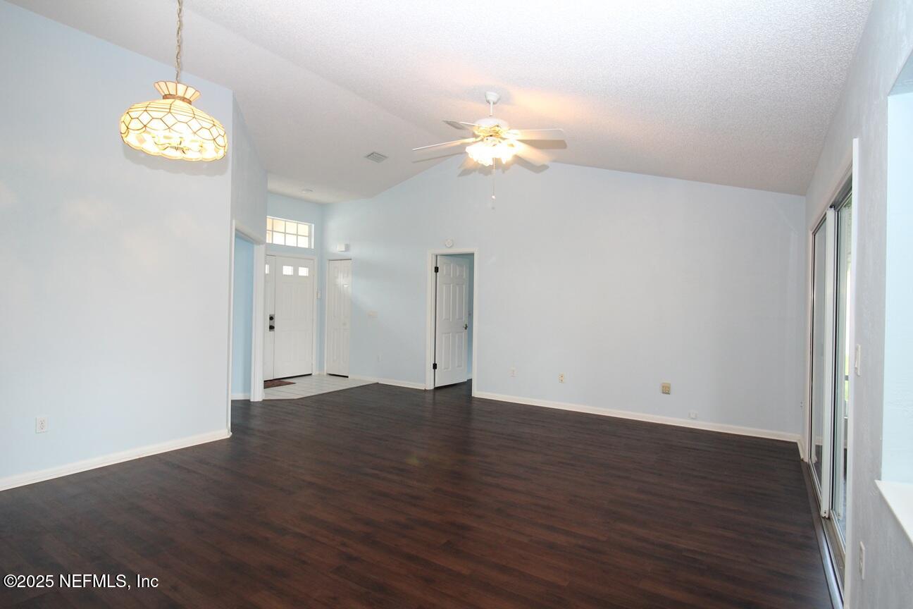 48 Westover Lane Palm Coast, FL 32164 - Photo 6 of 20 an empty room with wooden floor and window