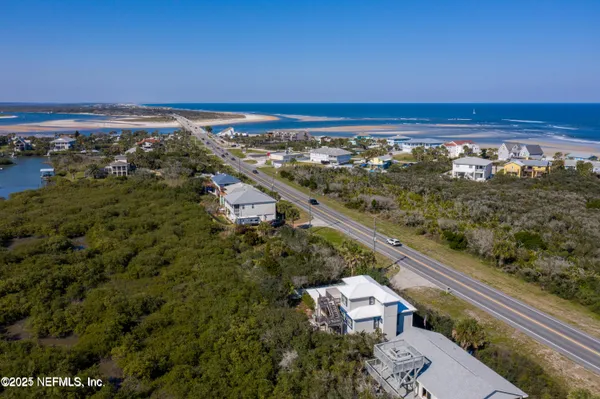 an aerial view of residential building and ocean view