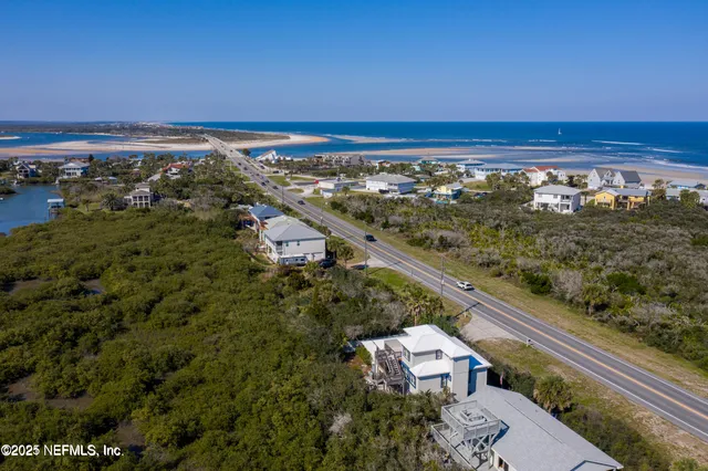 an aerial view of residential building and ocean view