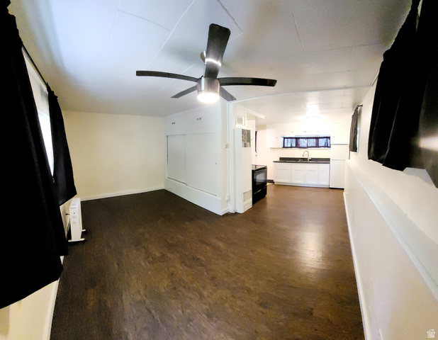 684 East 400 North Logan, UT 84321 - Photo 21 of 27 Open-concept living space featuring wood-finish flooring, a modern ceiling fan with lighting, and white walls