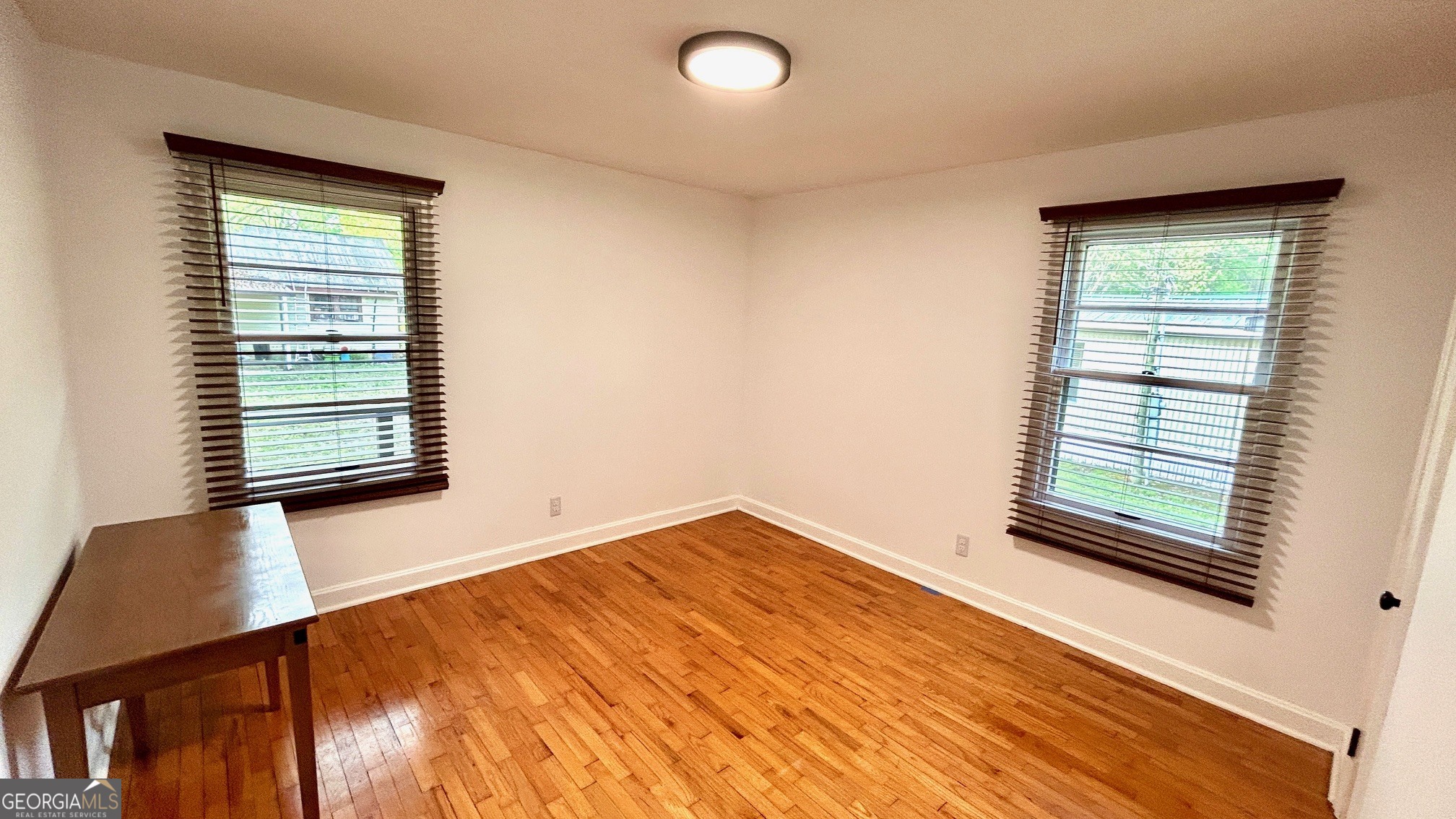 67 Dixie Park Drive Northwest Rome, GA 30165 - Photo 8 of 37 a view of an empty room with wooden floor and a window