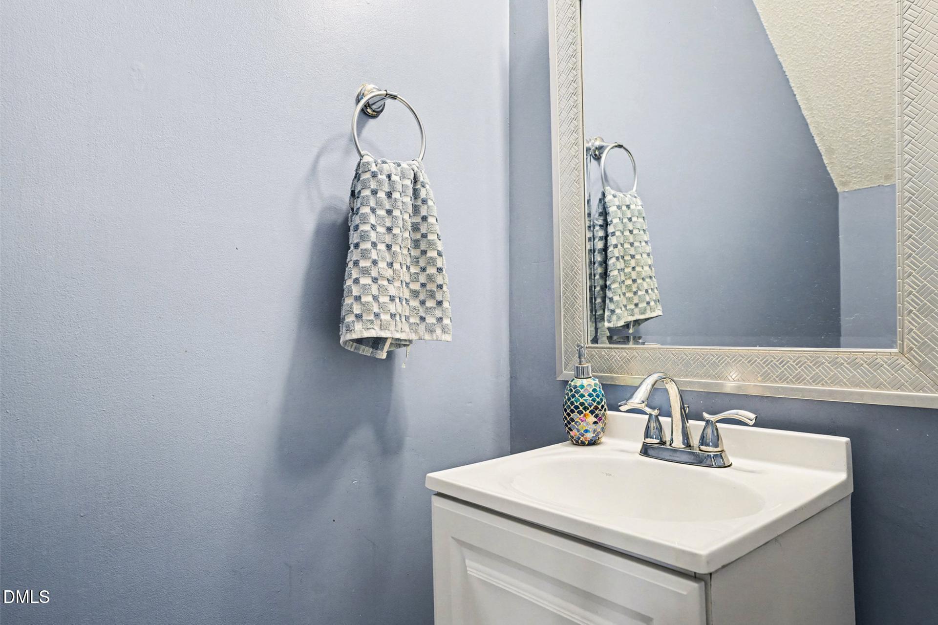5103 Jimmy Ridge Place Raleigh, NC 27610 - Photo 16 of 29 a bathroom with a sink and a mirror