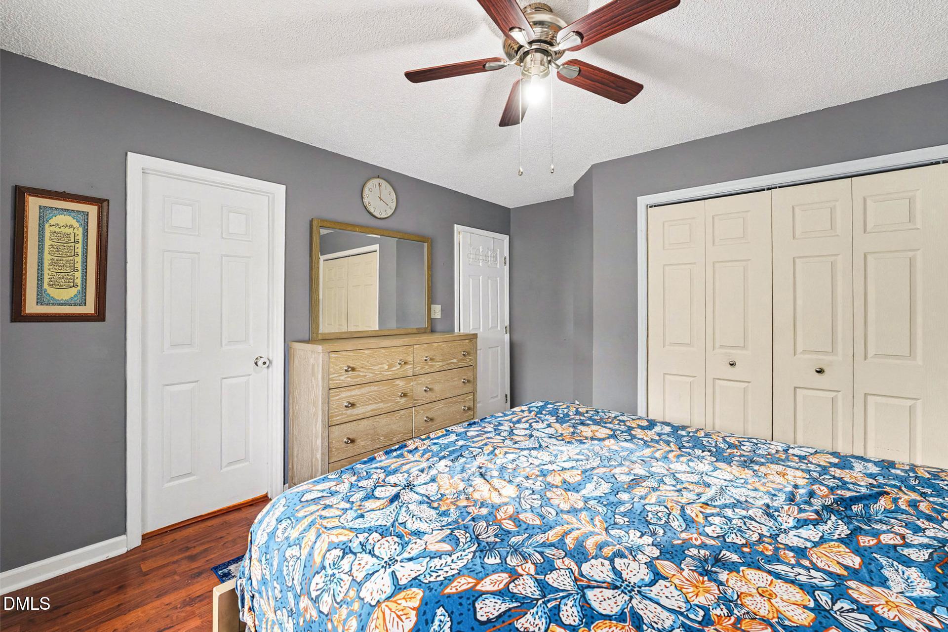 5103 Jimmy Ridge Place Raleigh, NC 27610 - Photo 19 of 29 a bedroom with a bed and a chandelier