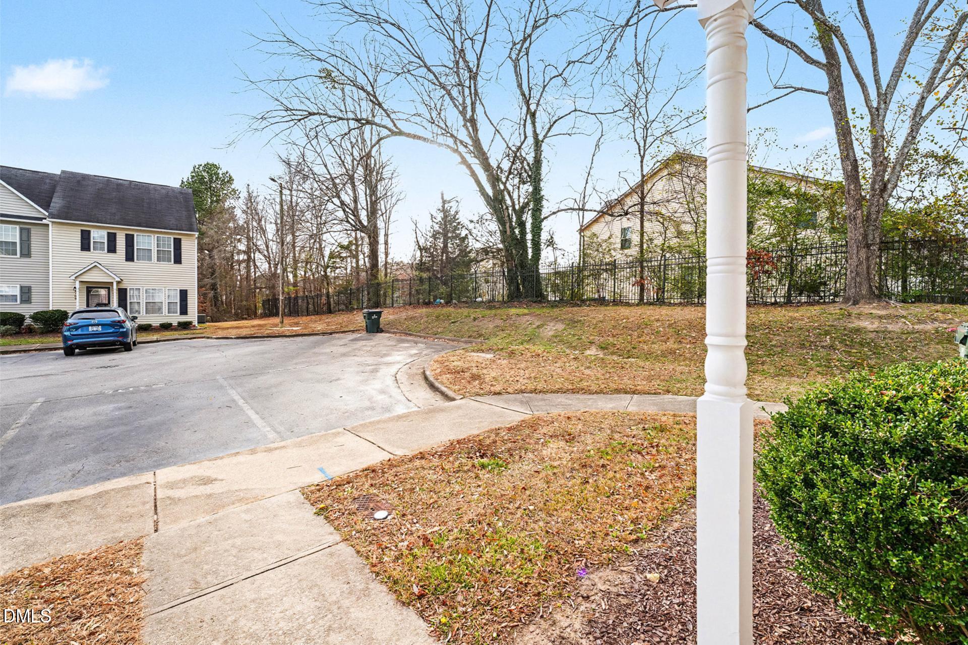 5103 Jimmy Ridge Place Raleigh, NC 27610 - Photo 26 of 29 a view of a street with a building on the roadside