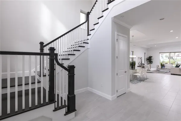 a view of a livingroom with furniture and stairs