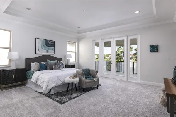 a spacious bedroom with a bed a couch and a window