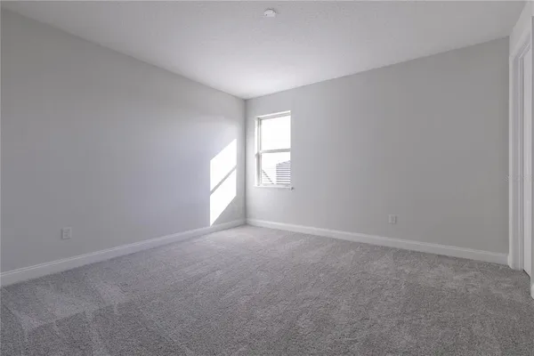 a view of an empty room and a window