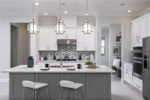 a kitchen with stainless steel appliances a sink and a refrigerator