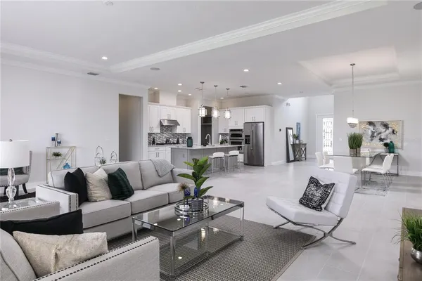 a living room with furniture and kitchen view