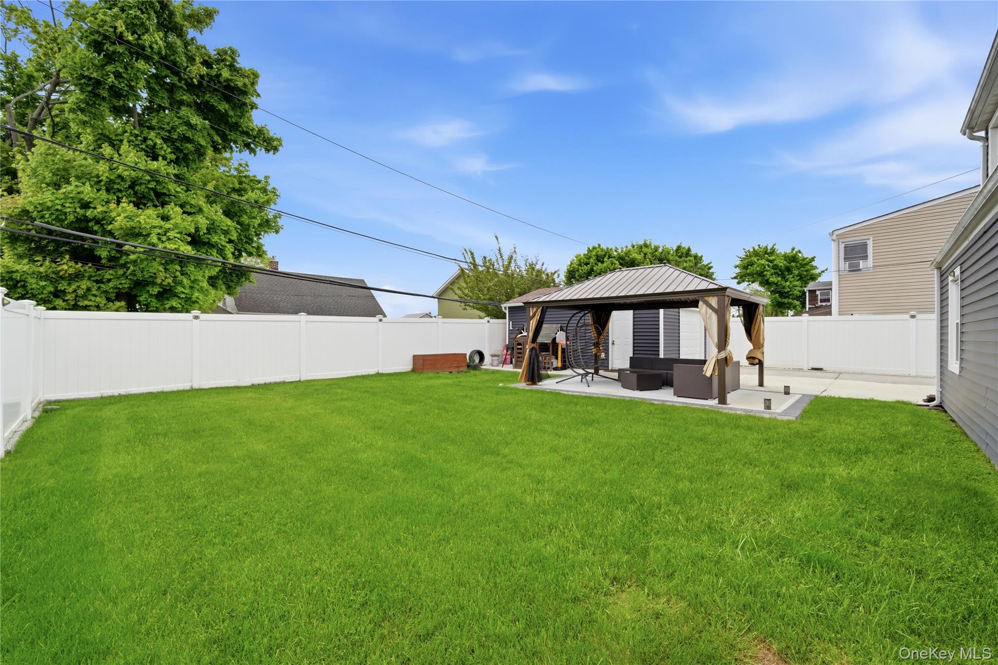 50 Ridge Lane Levittown, NY 11756 - Photo 25 of 27 a view of house with garden space and deck