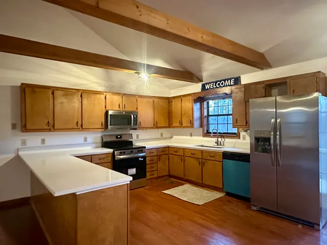 a view of a room with wooden floors and pool table