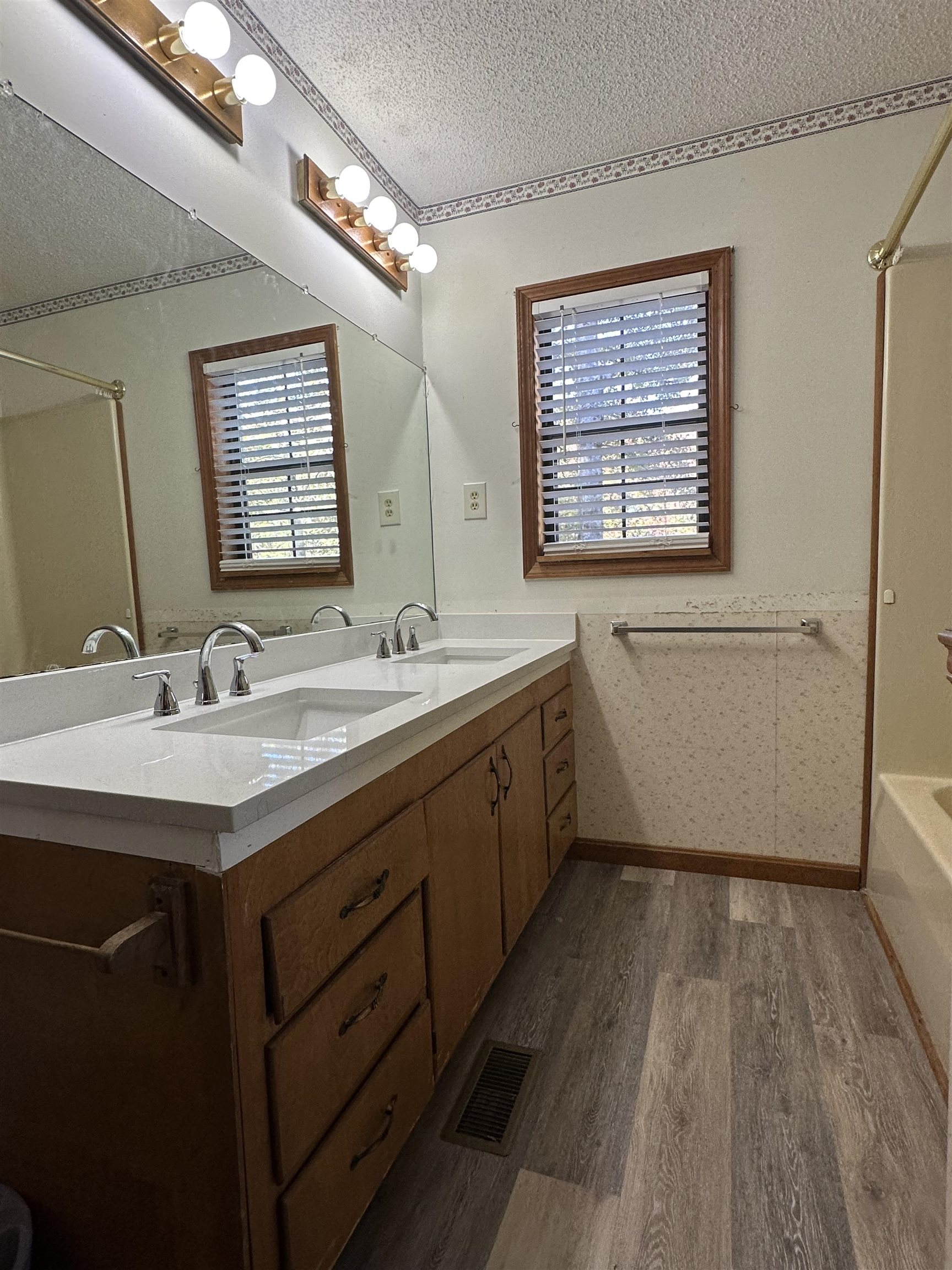 298 Matlock Road Ramer, TN 38367 - Photo 4 of 17 a bathroom with a double vanity sink a mirror and a bathtub