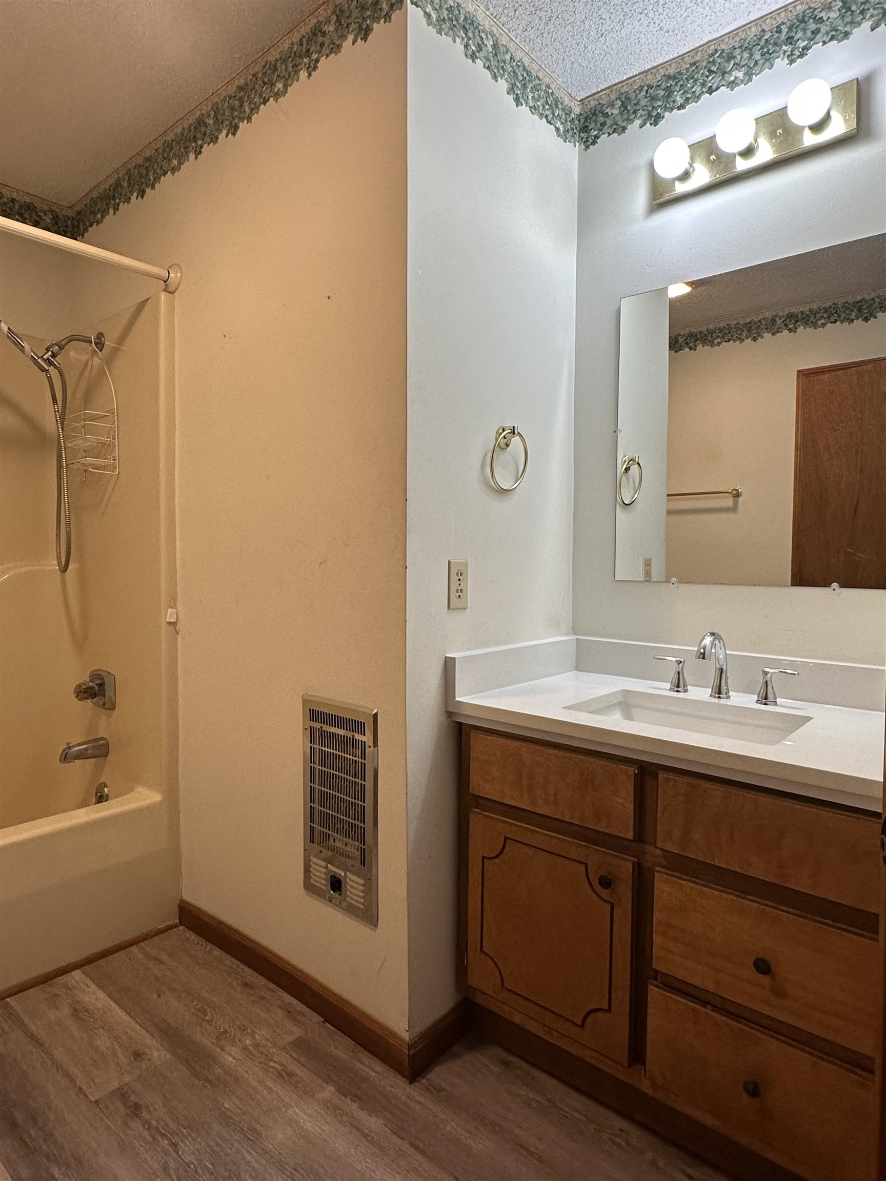 298 Matlock Road Ramer, TN 38367 - Photo 6 of 17 a bathroom with a granite countertop sink a mirror and a bathtub