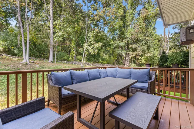 a view of a chairs and table on the deck