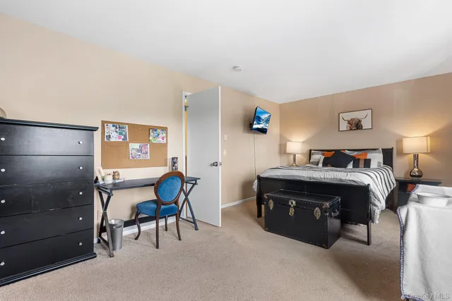 a bedroom with a bed and a chair in it