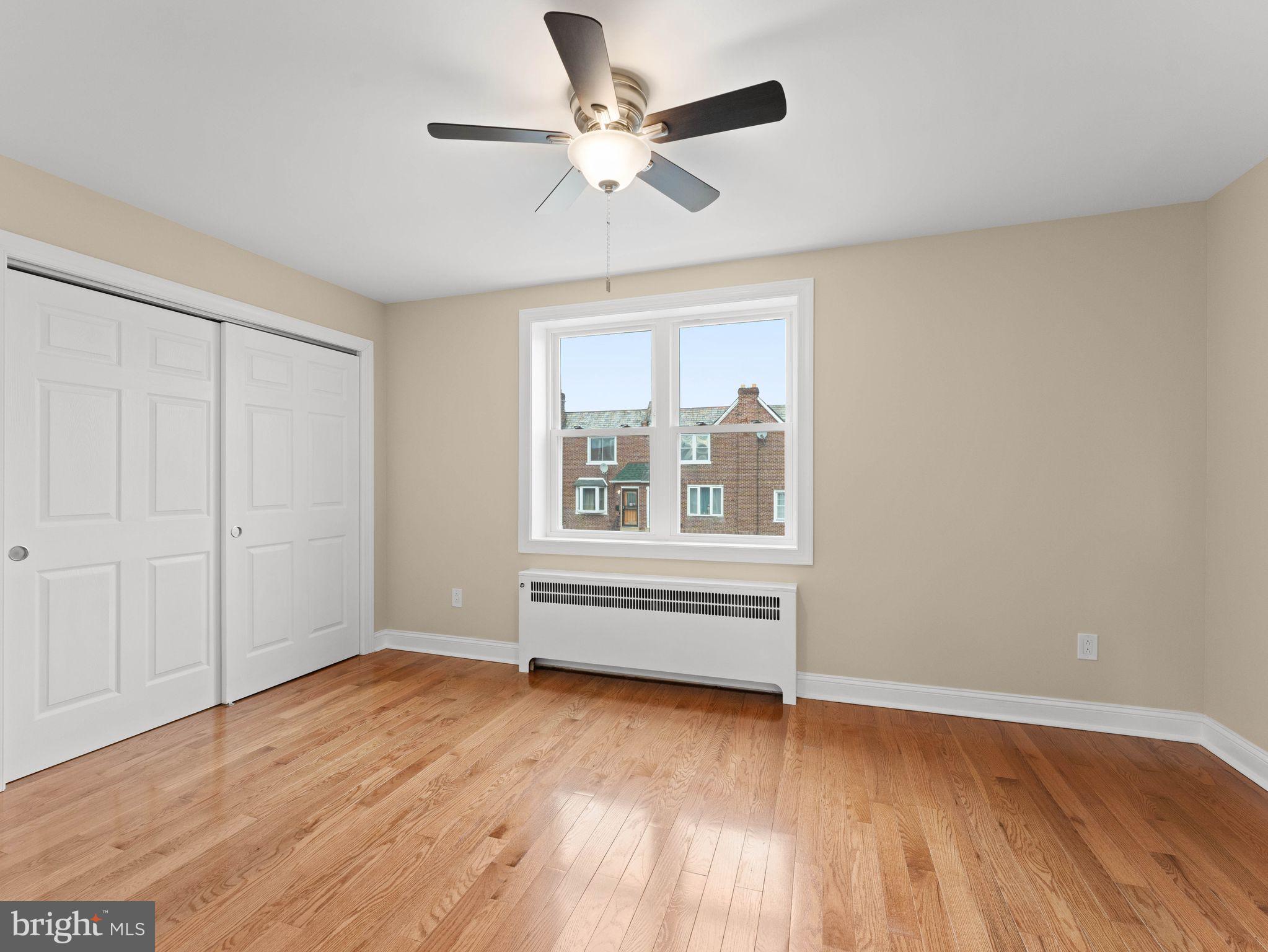 7510 Rugby Street Philadelphia, PA 19150 - Photo 11 of 22 wooden floor in an empty room with a window