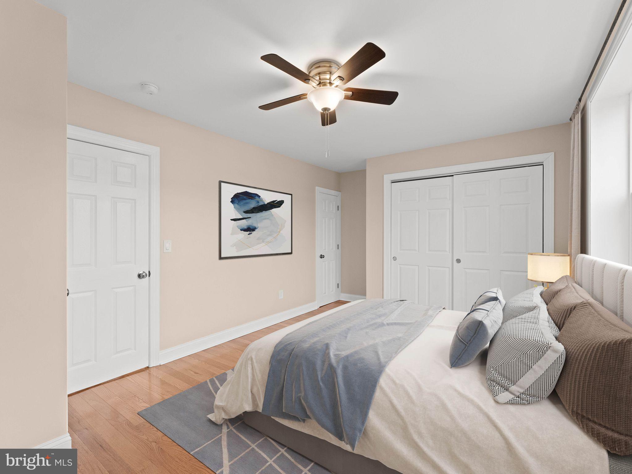 7510 Rugby Street Philadelphia, PA 19150 - Photo 8 of 22 a bedroom with a large bed and a ceiling fan