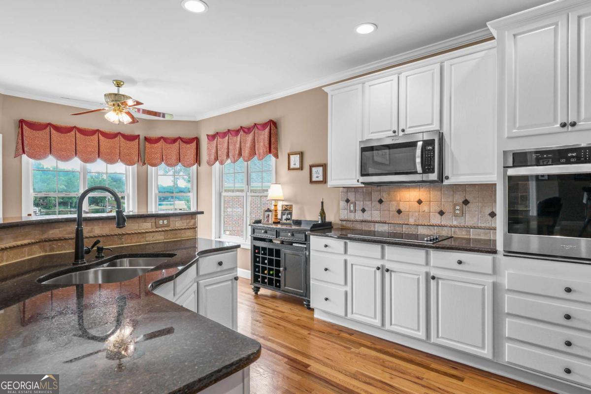 1283 Heritage Drive Villa Rica, GA 30180 - Photo 18 of 75 a kitchen with stainless steel appliances granite countertop a stove a sink and a microwave
