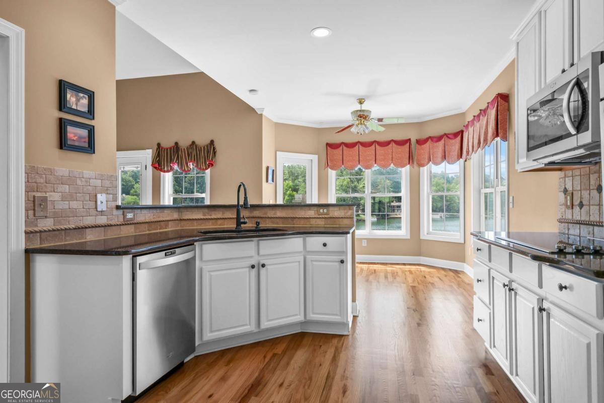 1283 Heritage Drive Villa Rica, GA 30180 - Photo 19 of 75 a kitchen with granite countertop a sink and wooden floor