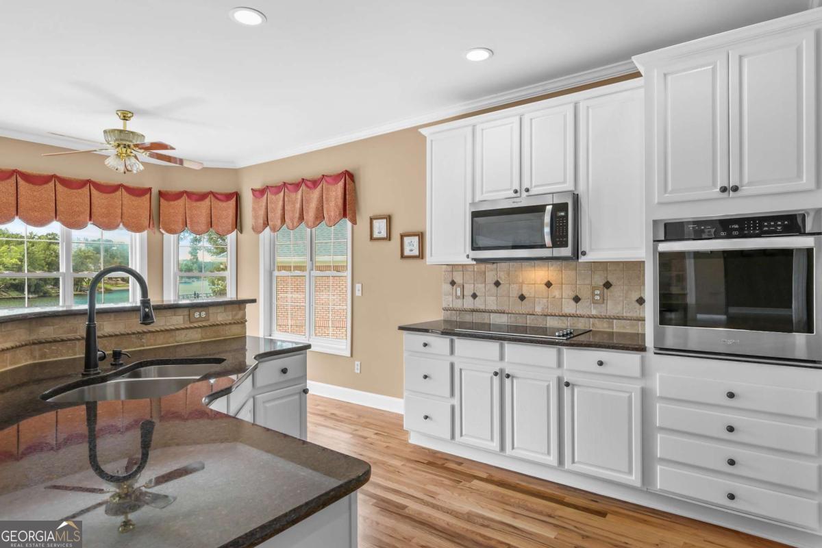 1283 Heritage Drive Villa Rica, GA 30180 - Photo 20 of 75 a kitchen with granite countertop a stove a sink and a refrigerator