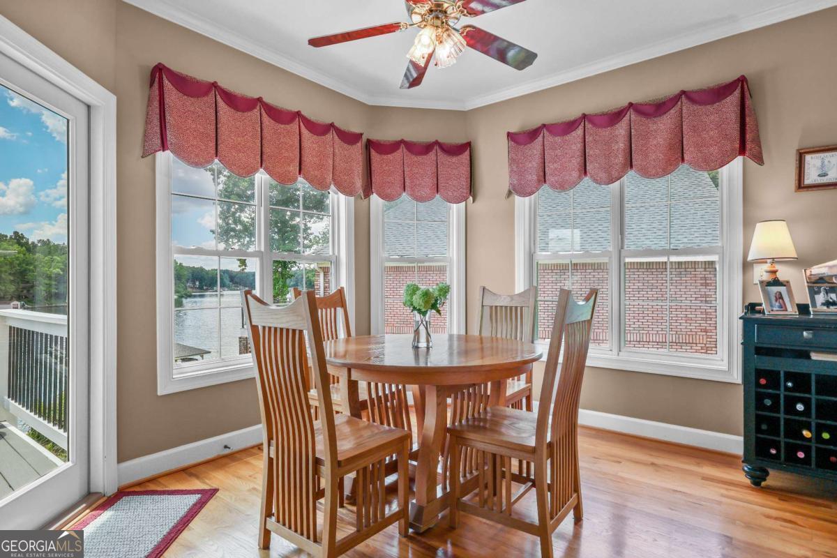 1283 Heritage Drive Villa Rica, GA 30180 - Photo 23 of 75 a dining room with furniture a chandelier and wooden floor