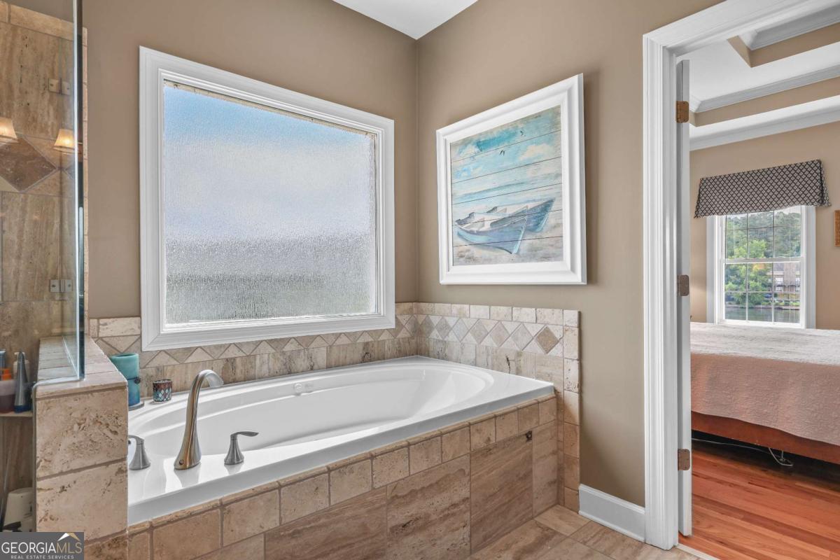 1283 Heritage Drive Villa Rica, GA 30180 - Photo 27 of 75 a bath tub sitting next to a window