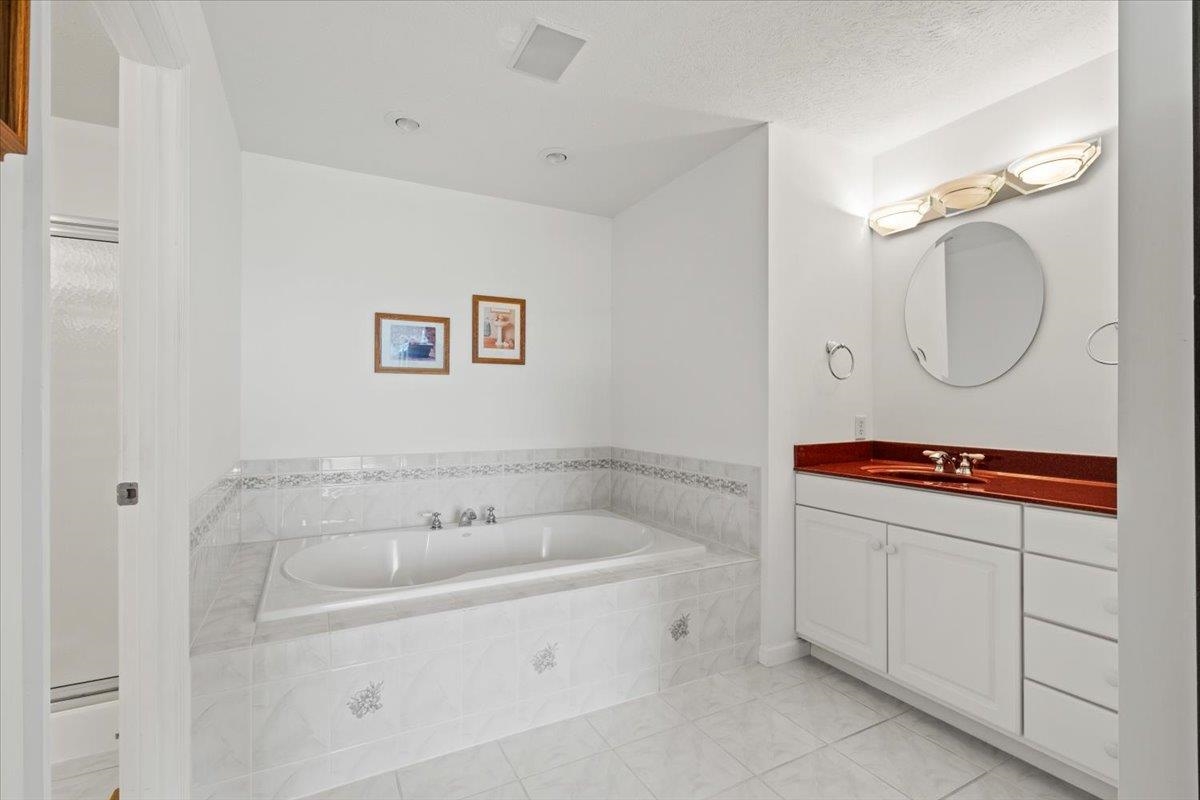 3740 Davis Road Penn Laird, VA 22846 - Photo 19 of 34 a bathroom with a bathtub sink mirror and vanity
