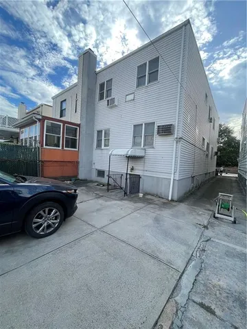 a view of a car park in front of house