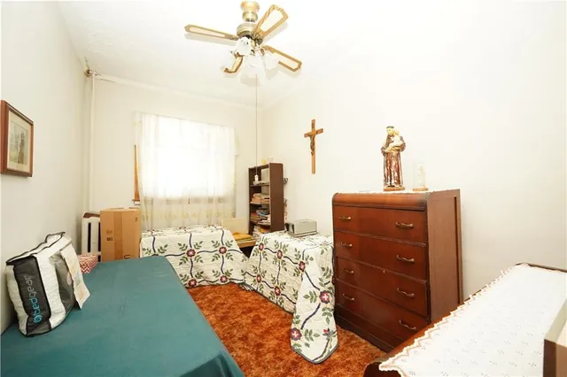 a bed room with a bed and a chair