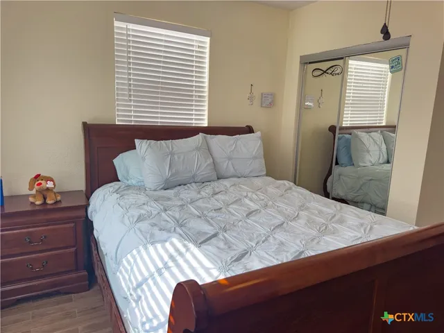 a bedroom with a bed and window