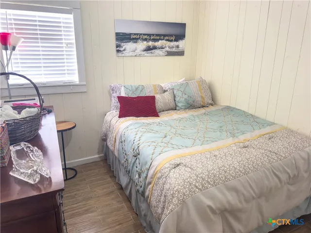 a large bed sitting in a bedroom next to a window