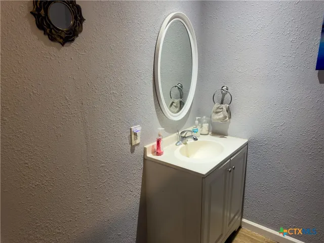 a bathroom with a sink and a mirror