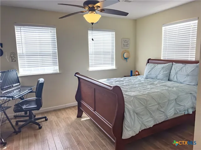 a bedroom with a bed and a desk