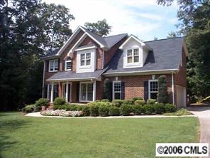 3965 Lake Shore Road South Denver, NC 28037 - Photo 1 of 8 a front view of a house with a yard and garage