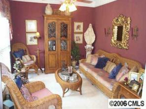 3965 Lake Shore Road South Denver, NC 28037 - Photo 2 of 8 a living room with furniture a chandelier and a mirror