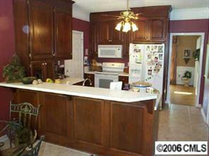 3965 Lake Shore Road South Denver, NC 28037 - Photo 4 of 8 a kitchen with a sink and a refrigerator