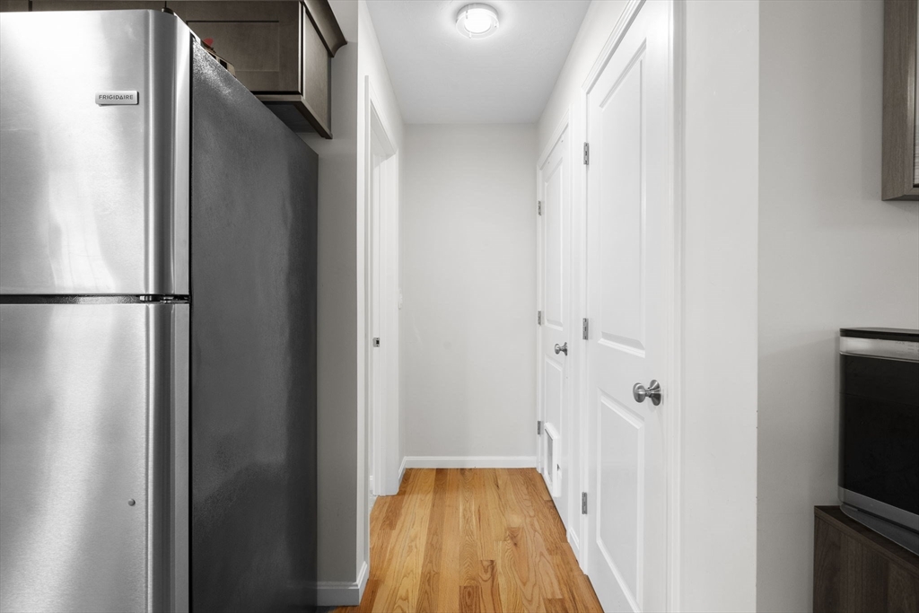 74 Riley Road, Unit 88 Tyngsboro, MA 01879 - Photo 9 of 31 a view of a kitchen from the hallway