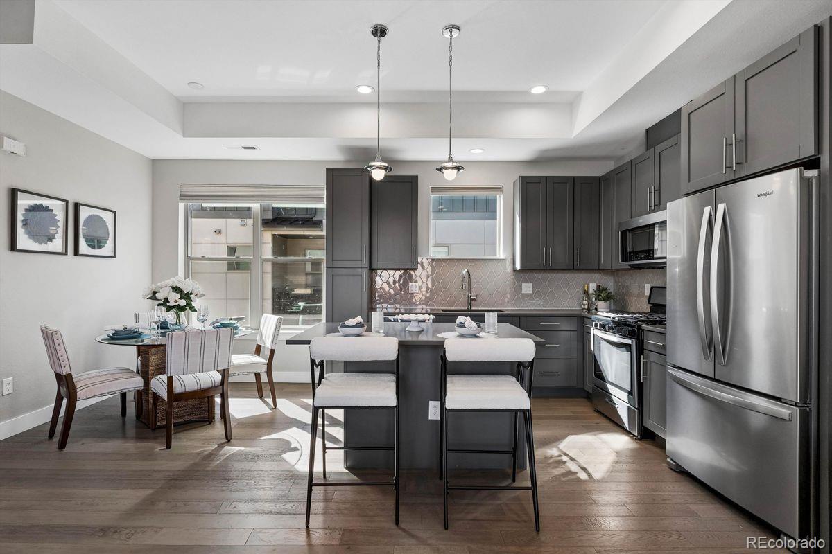 5366 Allison Street, Unit D Arvada, CO 80002 - Photo 2 of 28 a kitchen with a table chairs refrigerator and chairs