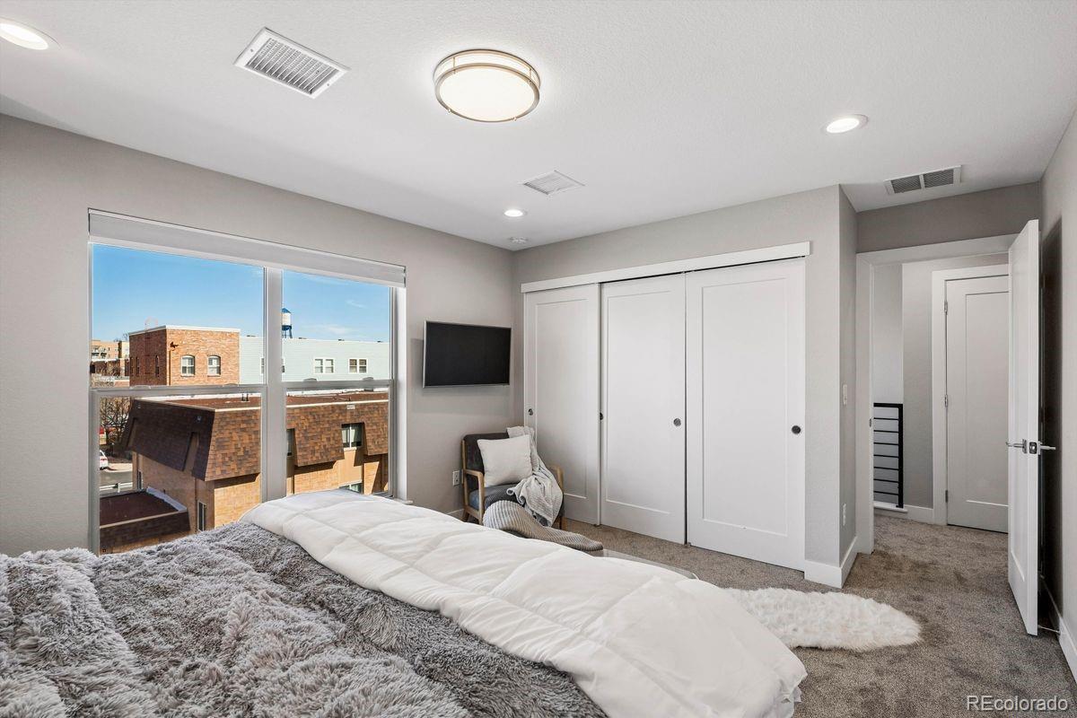5366 Allison Street, Unit D Arvada, CO 80002 - Photo 21 of 28 a bedroom with a bed and a flat screen tv