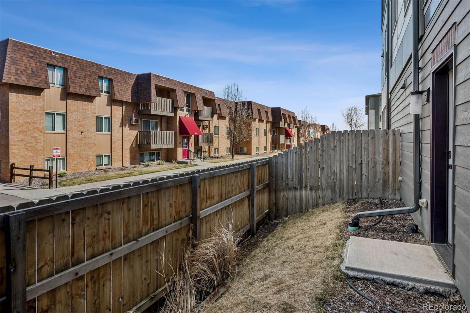5366 Allison Street, Unit D Arvada, CO 80002 - Photo 10 of 28 a view of tall buildings with wooden fence