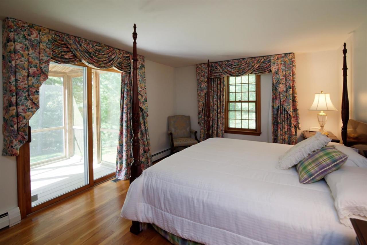 43 Piney Road Cotuit, MA 02635 - Photo 15 of 31 a bedroom with a large bed and a window