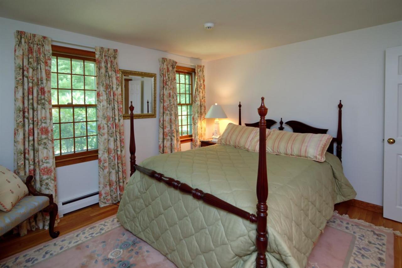 43 Piney Road Cotuit, MA 02635 - Photo 18 of 31 a bed sitting in a bedroom next to a window