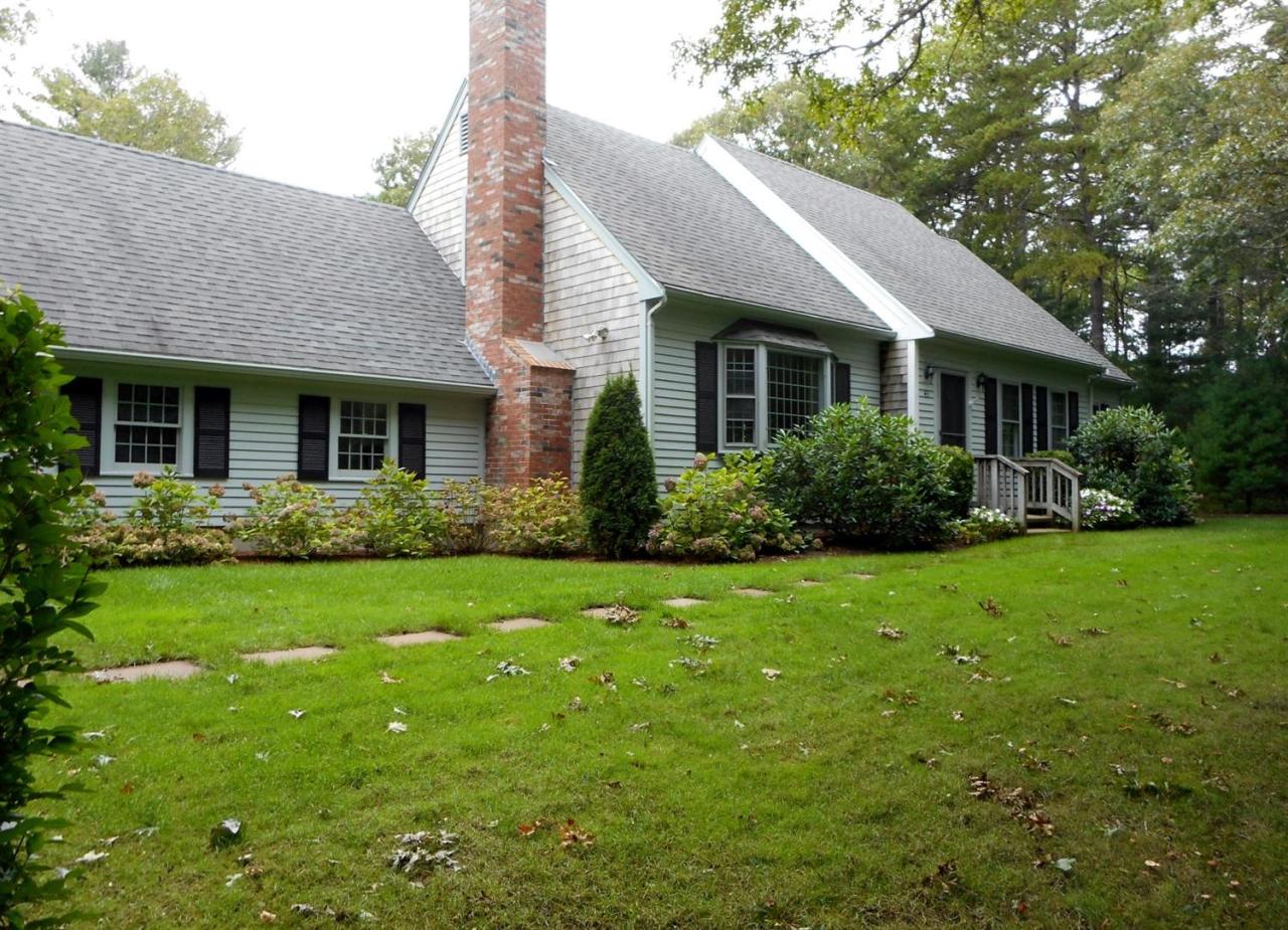 43 Piney Road Cotuit, MA 02635 - Photo 2 of 31 a view of a house with yard and plants