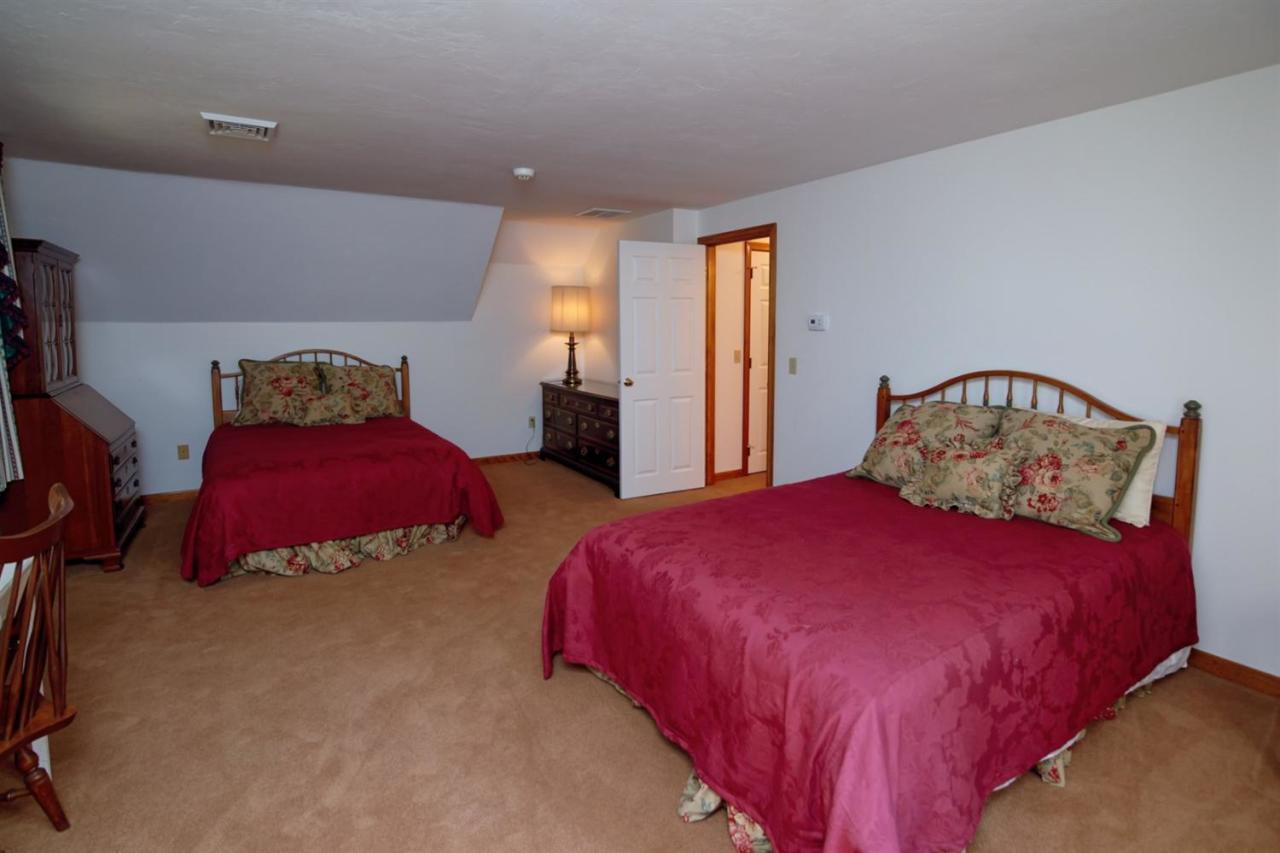 43 Piney Road Cotuit, MA 02635 - Photo 22 of 31 a bedroom with two beds and painting on the wall