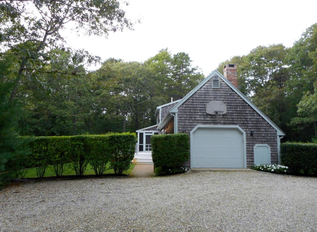 43 Piney Road Cotuit, MA 02635 - Photo 29 of 31 a front view of a house with a garden