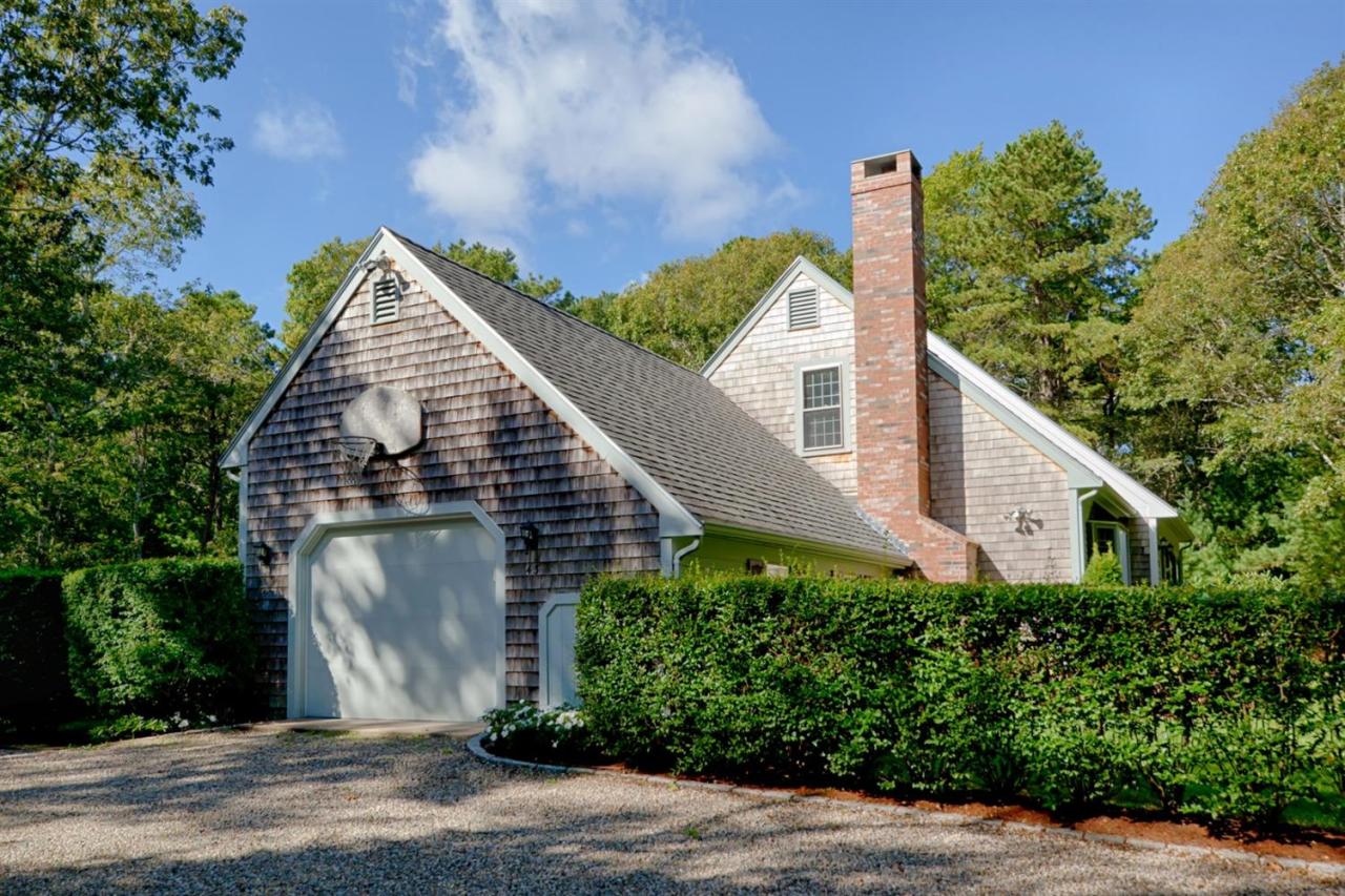 43 Piney Road Cotuit, MA 02635 - Photo 31 of 31 a view of a house with brick walls and plants